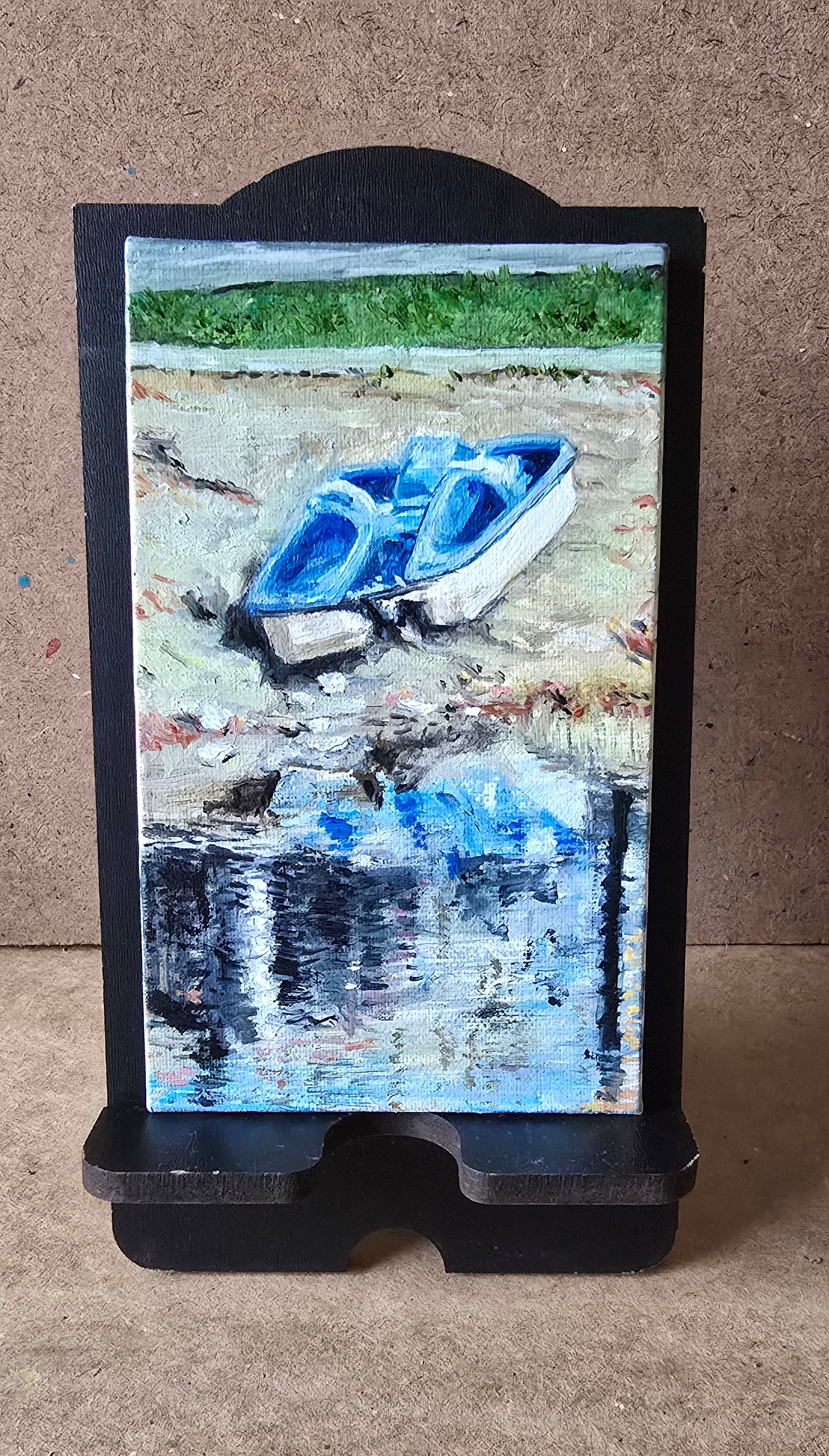 Digital tablet displaying a nature-themed wallpaper on a beige surface