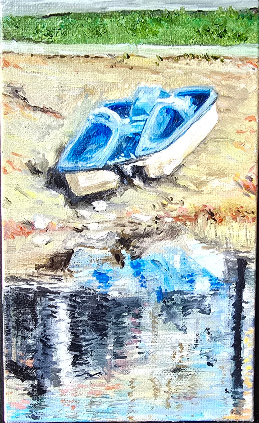 Small blue boat on a reflective water surface with a textured background