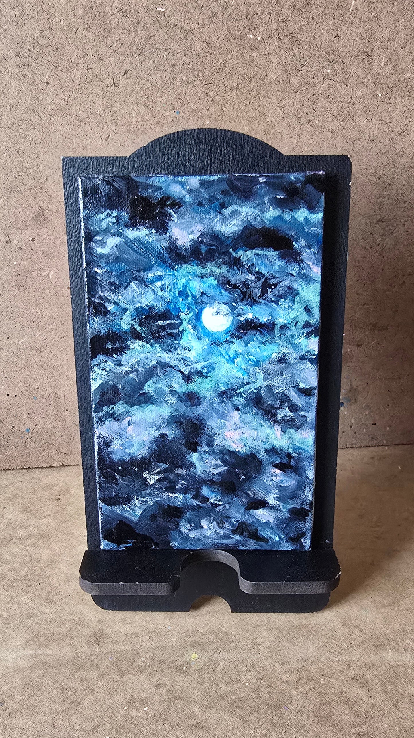 Blue stone slab on a black stand on a concrete floor