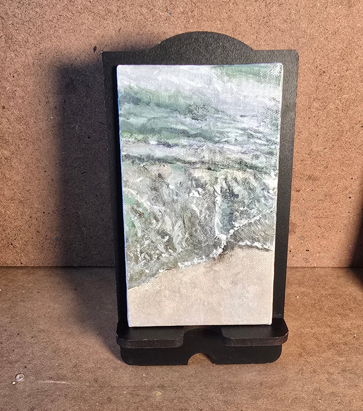Small screen displaying a nature scene on a brown surface
